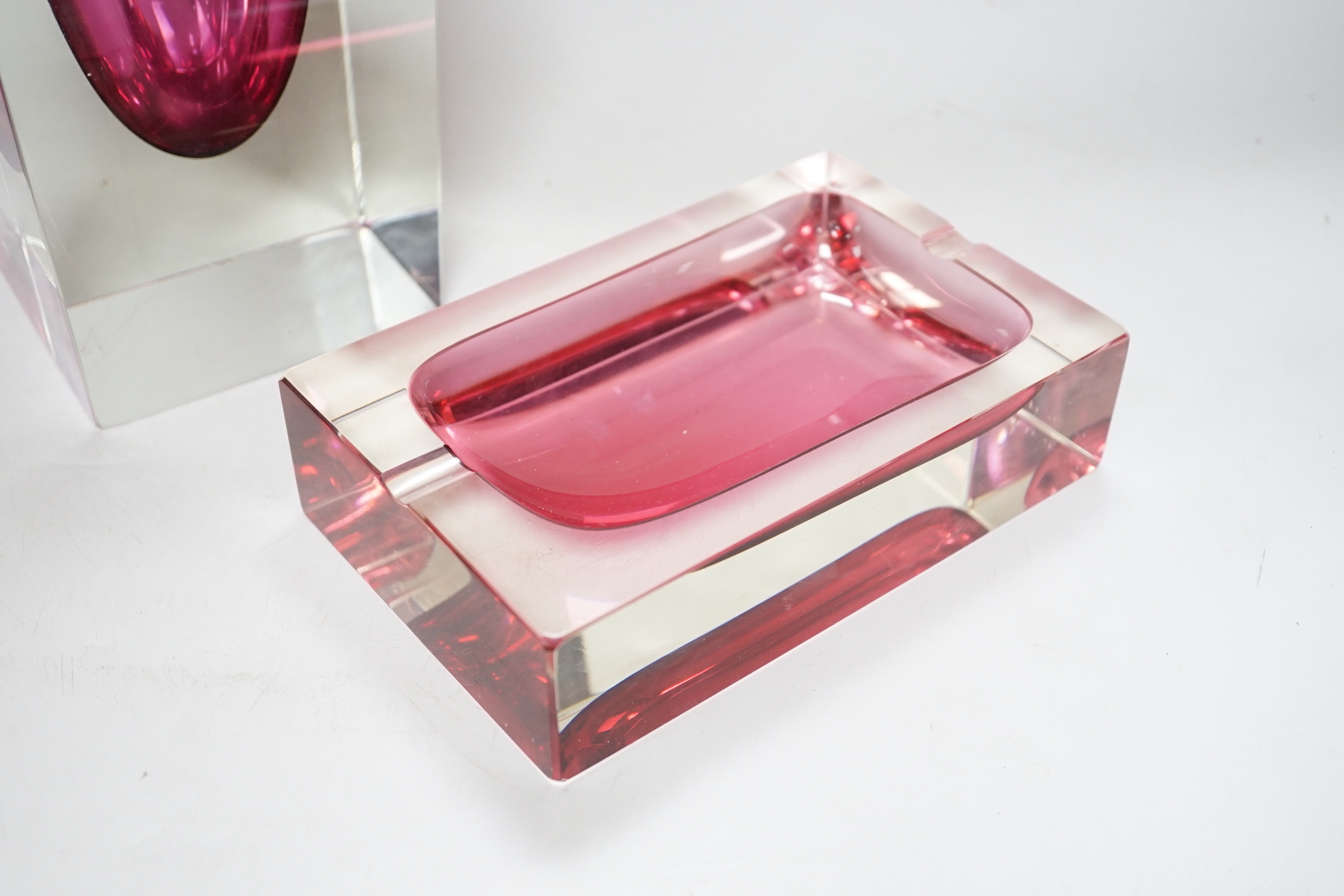 A large oversized Murano studio glass tear drop perfume bottle and a cranberry ashtray, the largest 45cm high